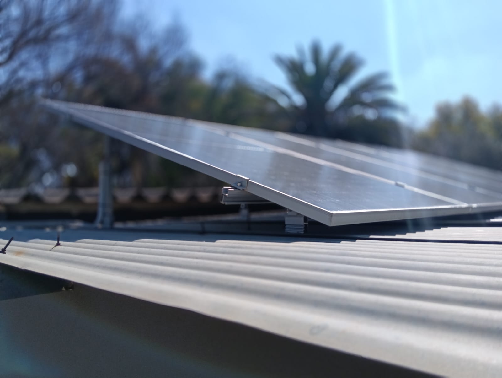 Close-up of solar panel edge and roof mounting hardware